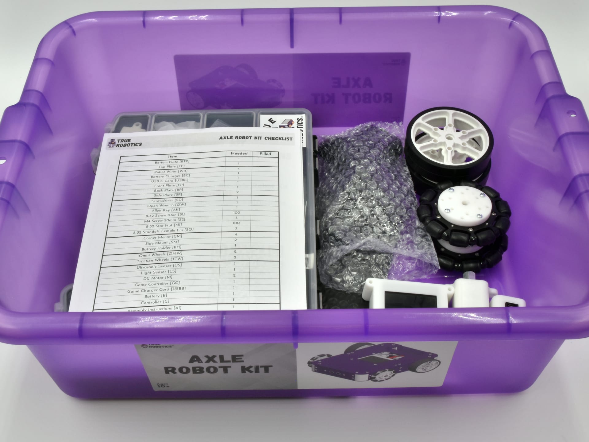 Inside the open Axle Robot Kit box: the parts checklist on top, the wheels and the bagged parts beside it